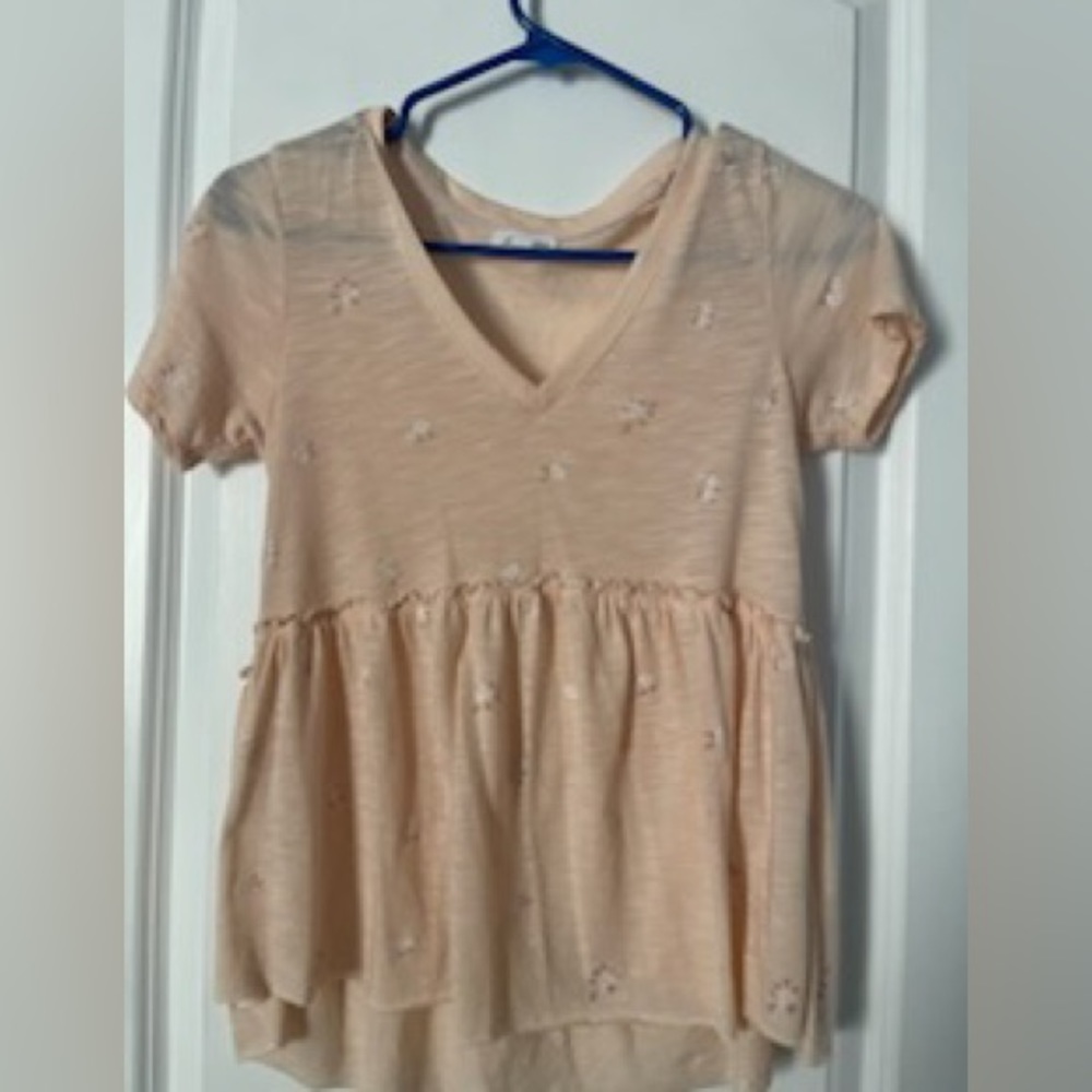 peach shirt with white flowers